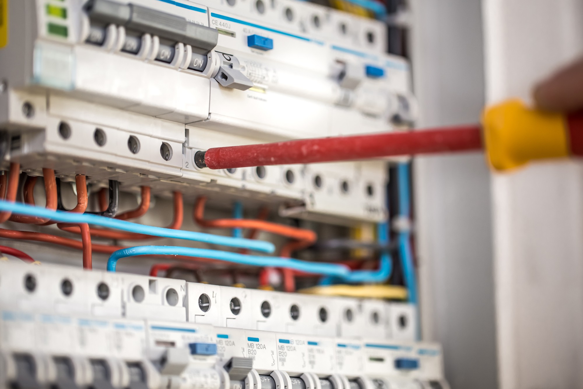 man-electrical-technician-working-switchboard-with-fuses-installation-connection-electrical-equipment-close-up (1)